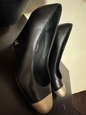 CHANEL Black Leather Wedge Pumps with Gold Cap Toe
